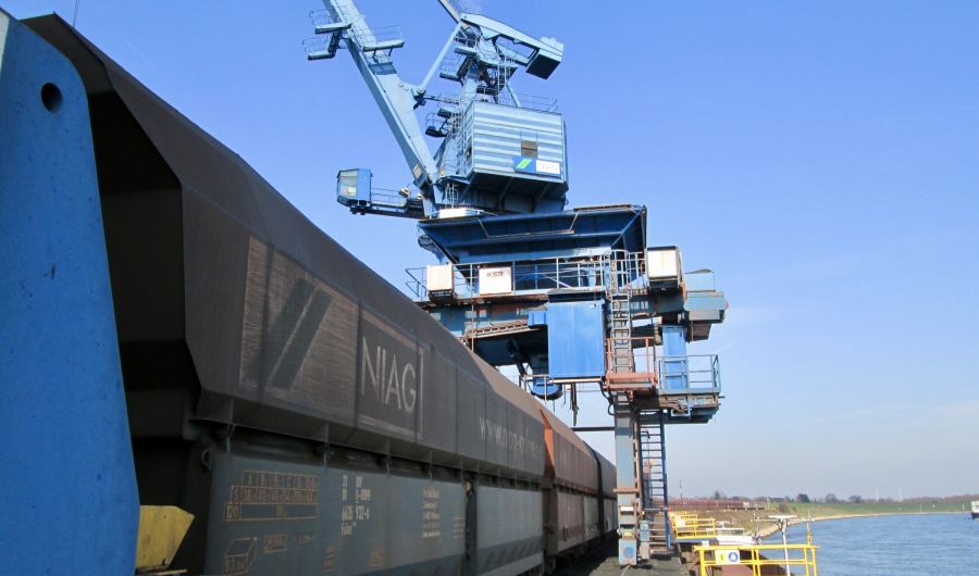 Ein Güterzug im Rheinhafen Orsoy mit Hafenkran im Hintergrund